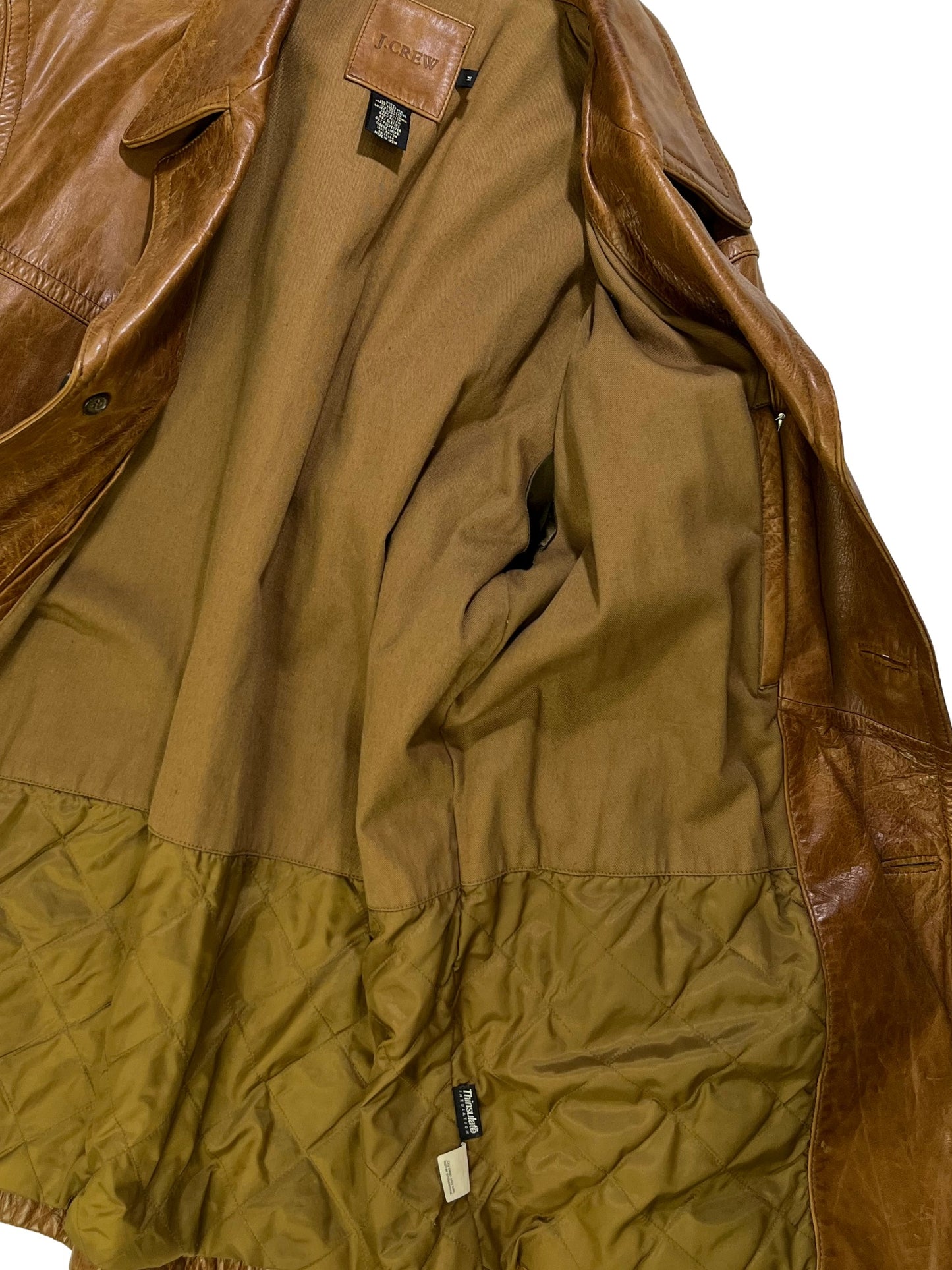 inside of Vintage 1990s J.Crew brown cowhide leather jacket with natural patina, wide lapel collar, and button-front closure.
