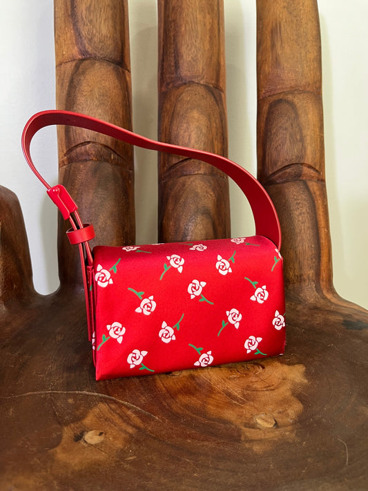 Shushu/Tong red satin mini bag with white rose print, structured silhouette, and red leather strap from the 2022 collection.