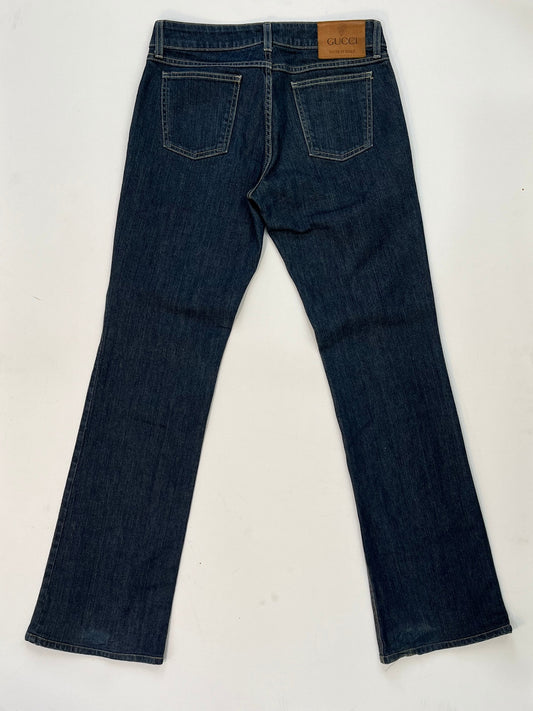 back of Gucci dark blue denim jeans in straight-leg cut with leather Gucci logo patch at back waistband, Italian size 44.
