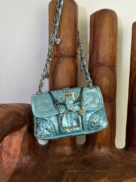 Vintage Luella metallic turquoise snakeskin handbag with silver buckle, chain strap, and signature heart charms, early 2000s Y2K It-bag.