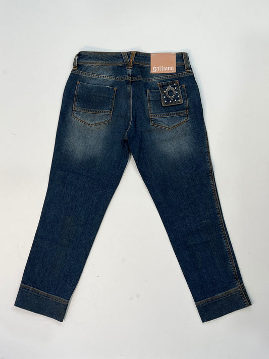 Vintage Galliano mid-wash denim jeans with pearl studded front pockets, embellished back pocket patch with pearls and silver detail, and cropped hem.