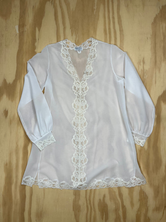 Front view of vintage Emilio Pucci sheer white tunic blouse with lace trim.