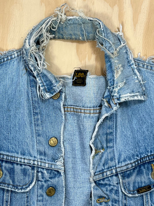 Close-up of Lee denim vest collar with heavy fraying and Lee label tag.