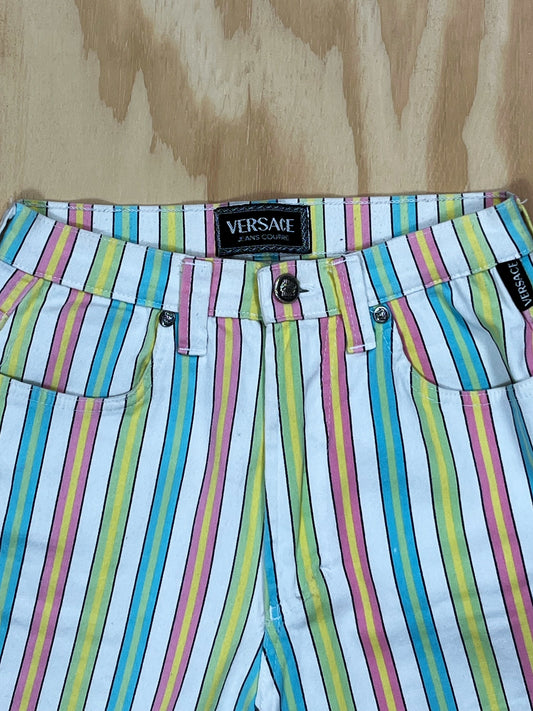 Close-up of Versace Jeans Couture 1990s label and multicolor stripe fabric detail with logo button.