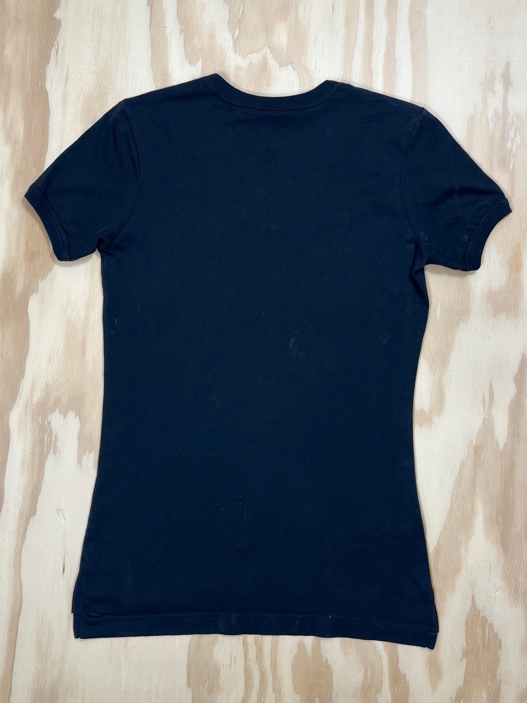 Vintage Vivienne Westwood Worlds End “Tits” T-shirt in black cotton featuring iconic monochrome chest print framed in red with gold Orb logo, rare 1990s archival piece from Westwood’s first store Worlds End.