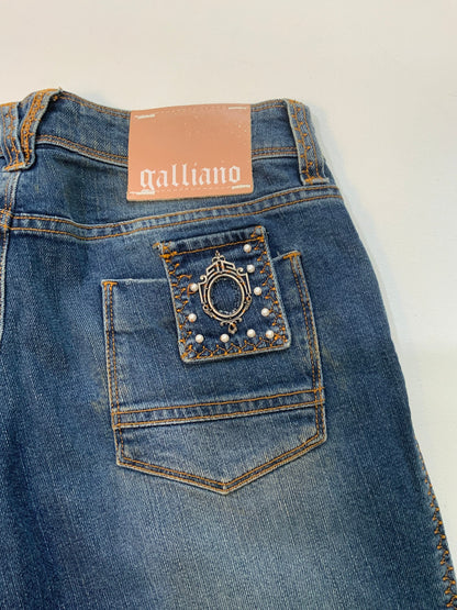 back of Vintage Galliano mid-wash denim jeans with pearl studded front pockets, embellished back pocket patch with pearls and silver detail, and cropped hem.