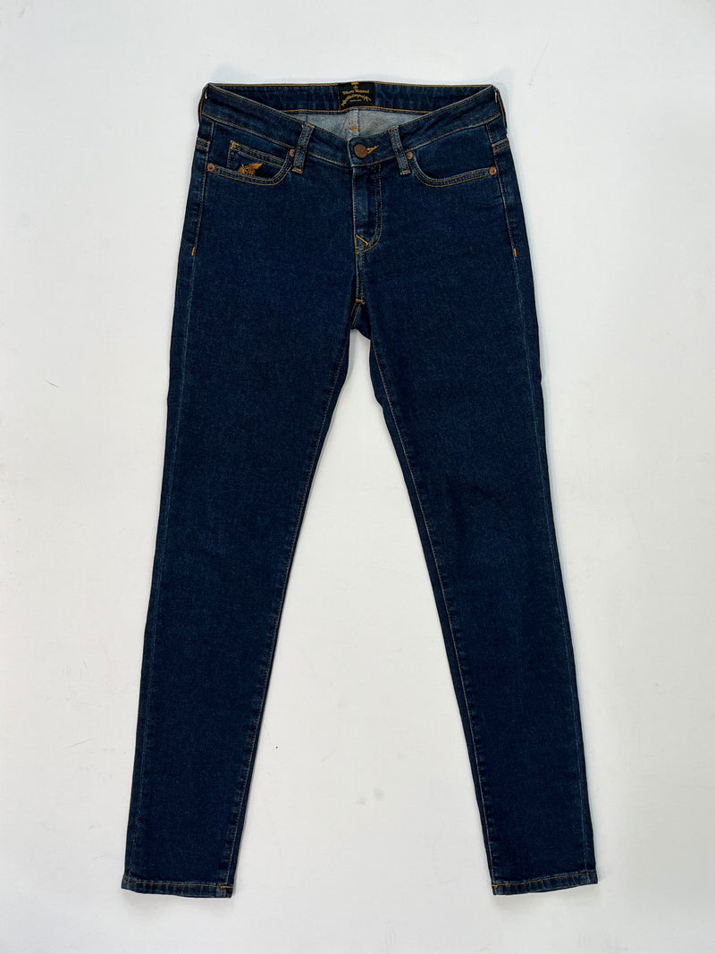 Vivienne Westwood dark blue skinny jeans with gold Orb embroidery on back pocket and black “Buy Less, Choose Well, Make It Last” patch at waistband.