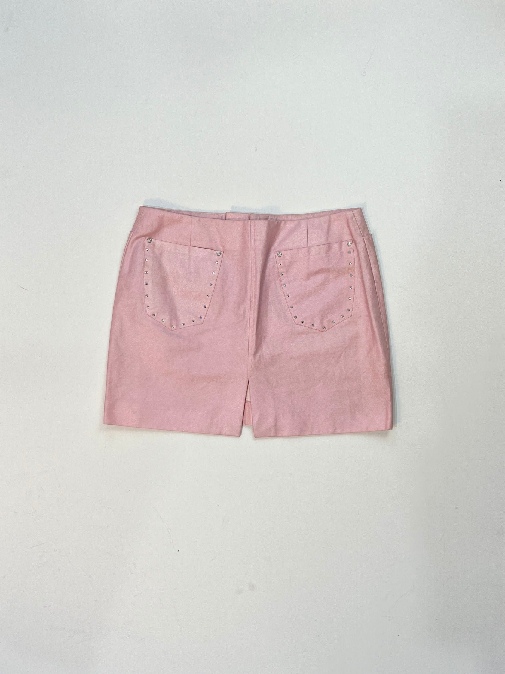 Back view of vintage Versace pink mini skirt with rhinestone studded patch pockets.