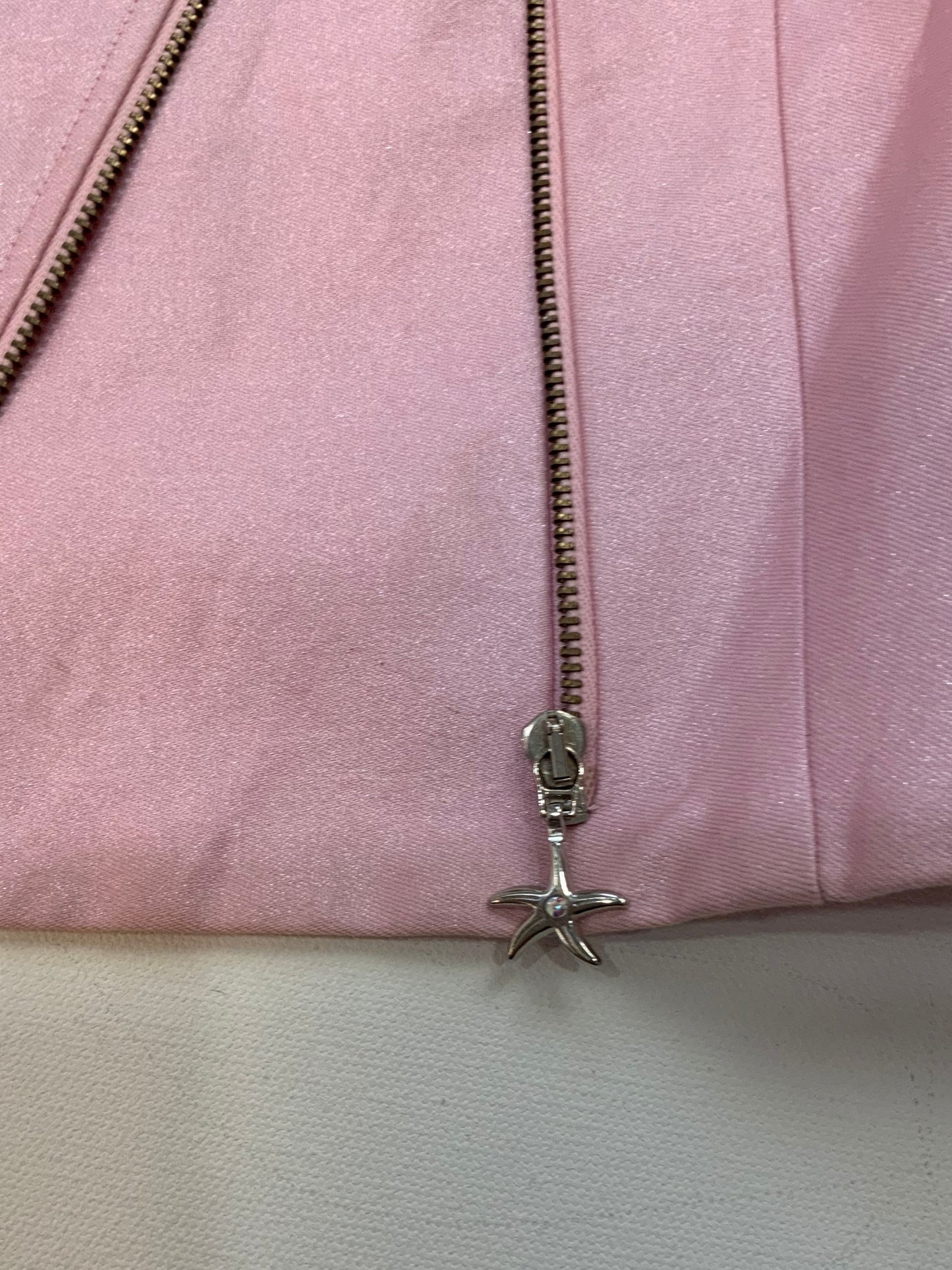 Zipper detail with starfish pull on Versace pink cropped jacket.