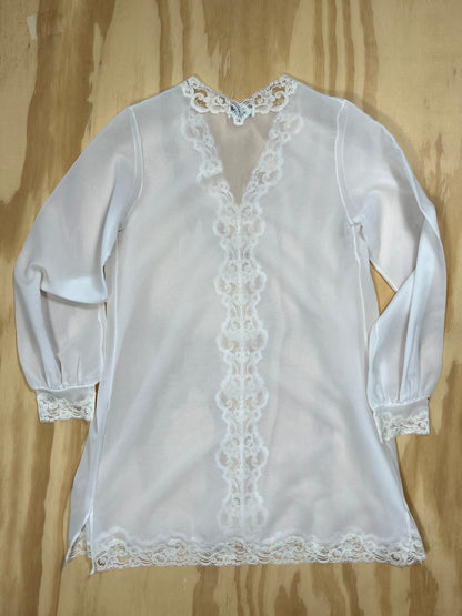 Back view of Emilio Pucci sheer tunic blouse with lace cuffs and hem.