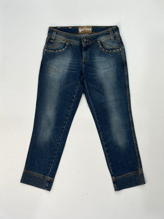Vintage Galliano mid-wash denim jeans with pearl studded front pockets, embellished back pocket patch with pearls and silver detail, and cropped hem.