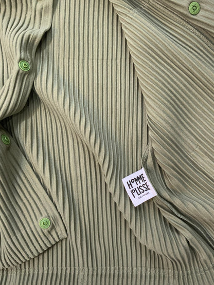 Issey Miyake Homme Plissé black pleated hoodie with drawstring hood, snap-button neckline, and kangaroo pocket.