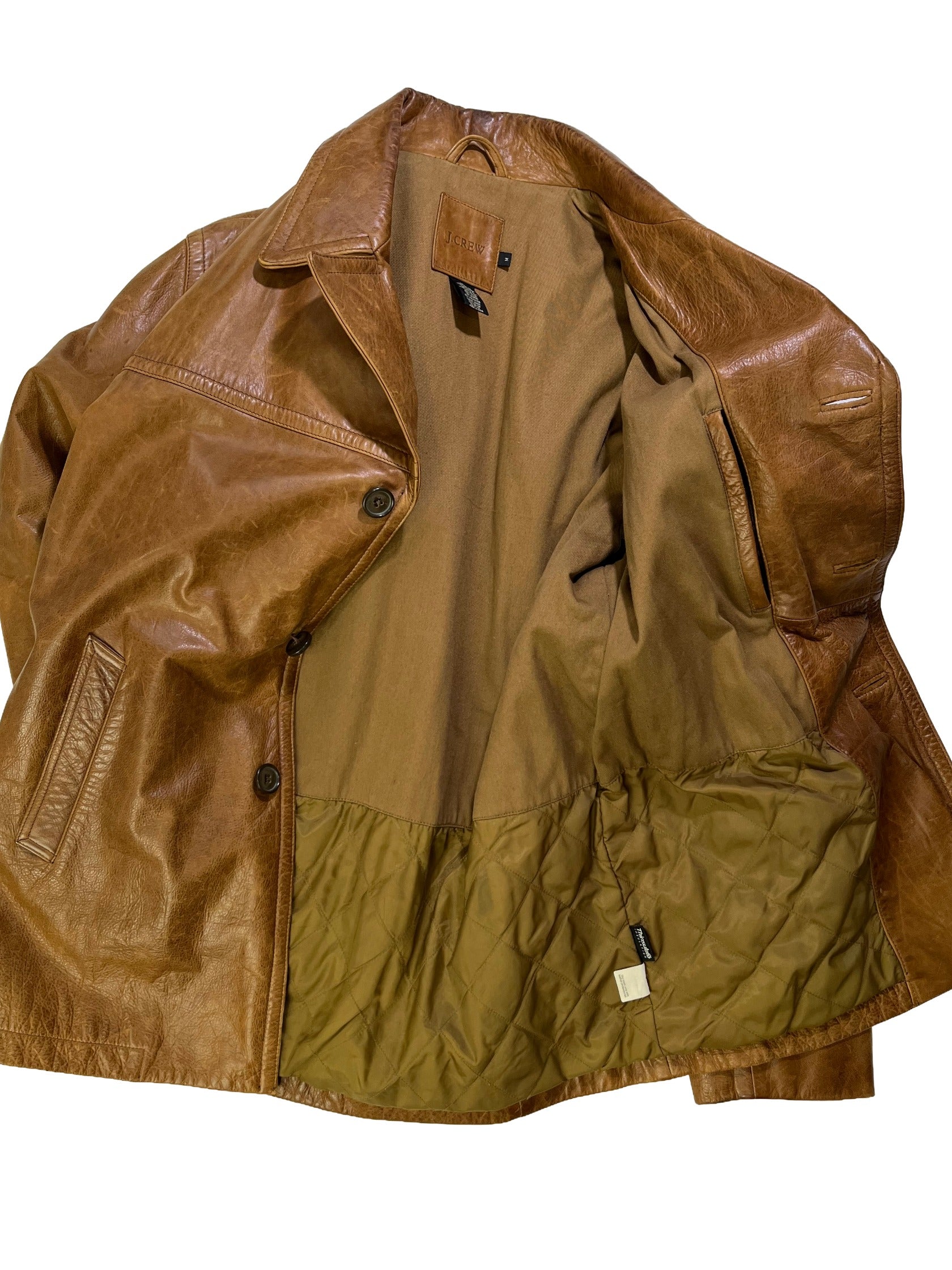 inside of Vintage 1990s J.Crew brown cowhide leather jacket with natural patina, wide lapel collar, and button-front closure.