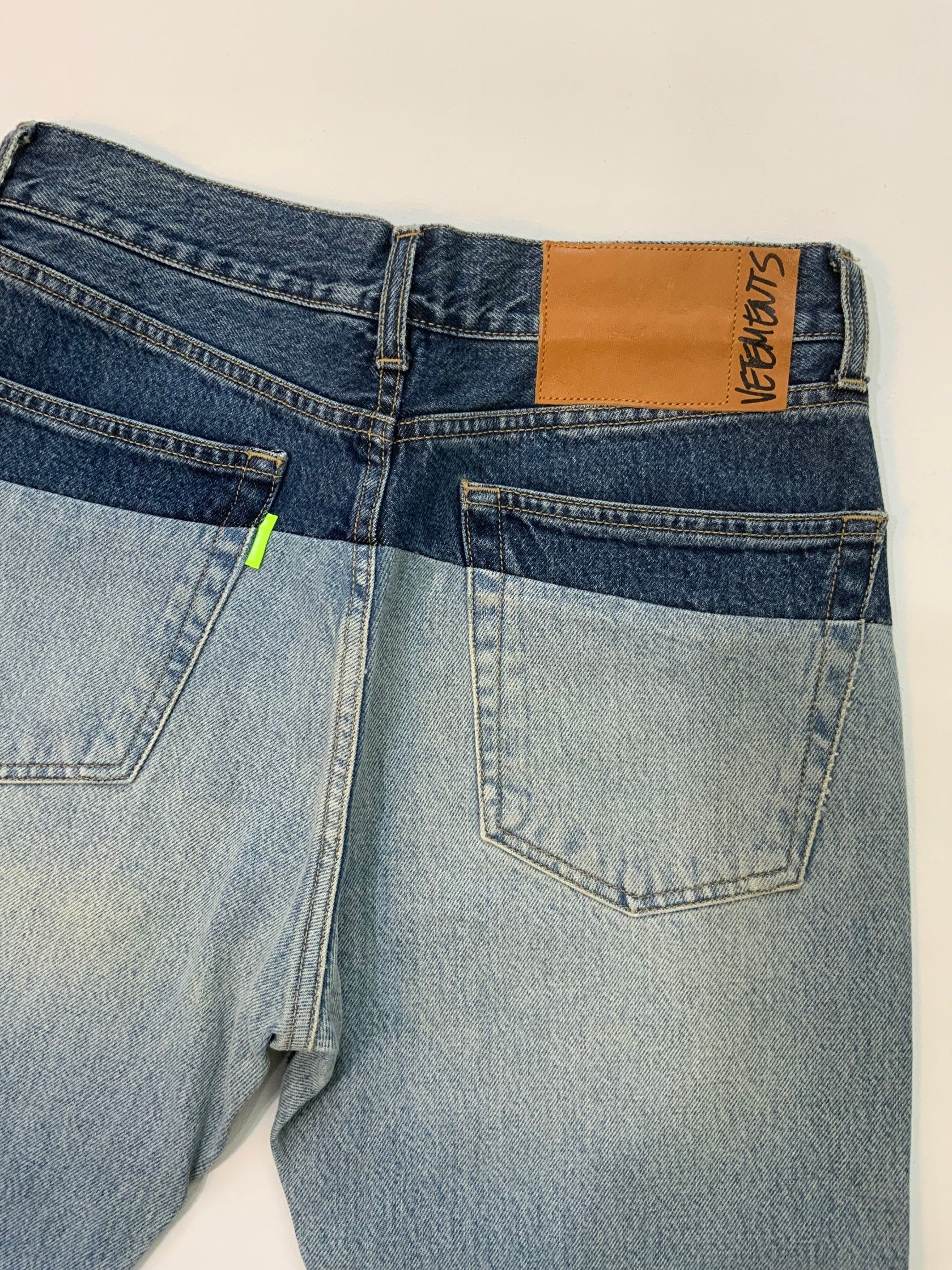 Vetements SS19 Sliced Cut-Up Jeans in two-tone blue denim with dark indigo waistband spliced onto light wash denim body.