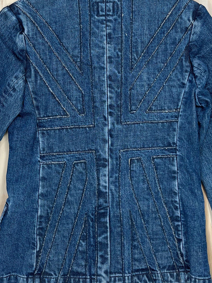 Close-up of Union Jack stitched panel on the back of a vintage denim blazer, washed indigo Y2K tailoring.