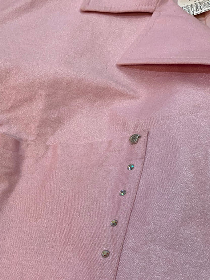 Close-up of Versace Medusa hardware and rhinestone details on pink cropped jacket pocket.