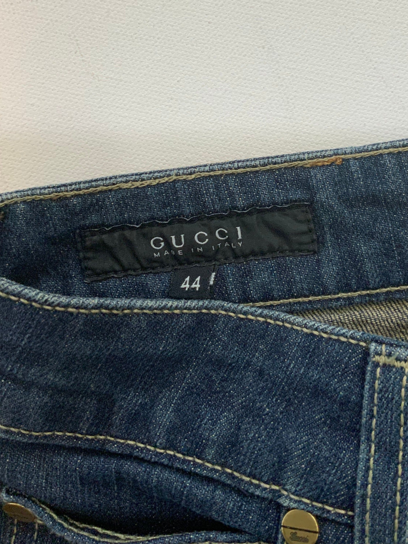 Gucci dark blue denim jeans in straight-leg cut with leather Gucci logo patch at back waistband, Italian size 44.