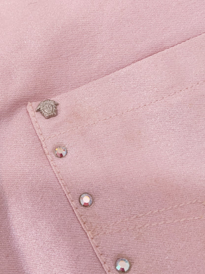 Close-up of a pink fabric with Medusa hard wear and rhinestones 