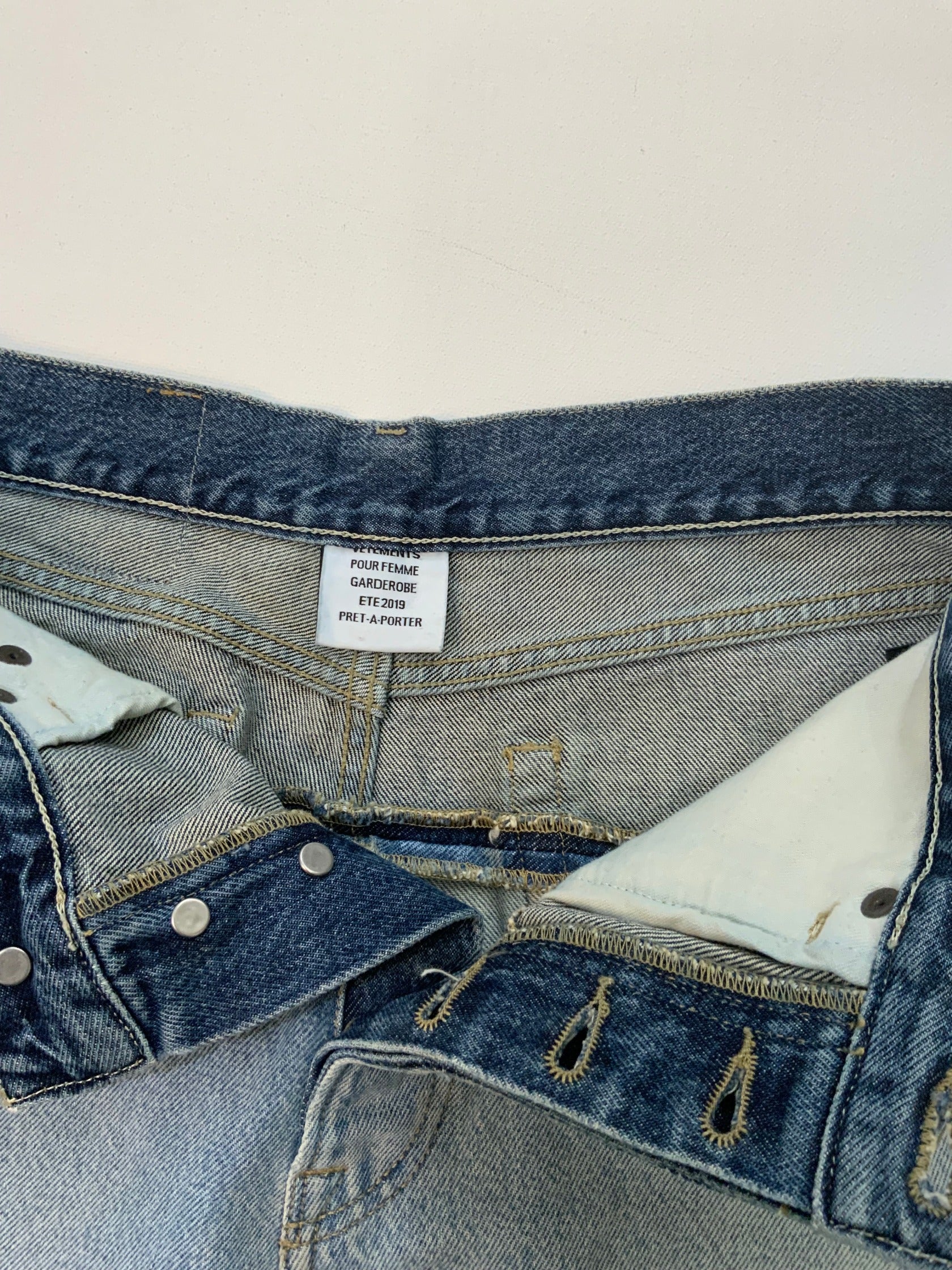 Vetements SS19 Sliced Cut-Up Jeans in two-tone blue denim with dark indigo waistband spliced onto light wash denim body.