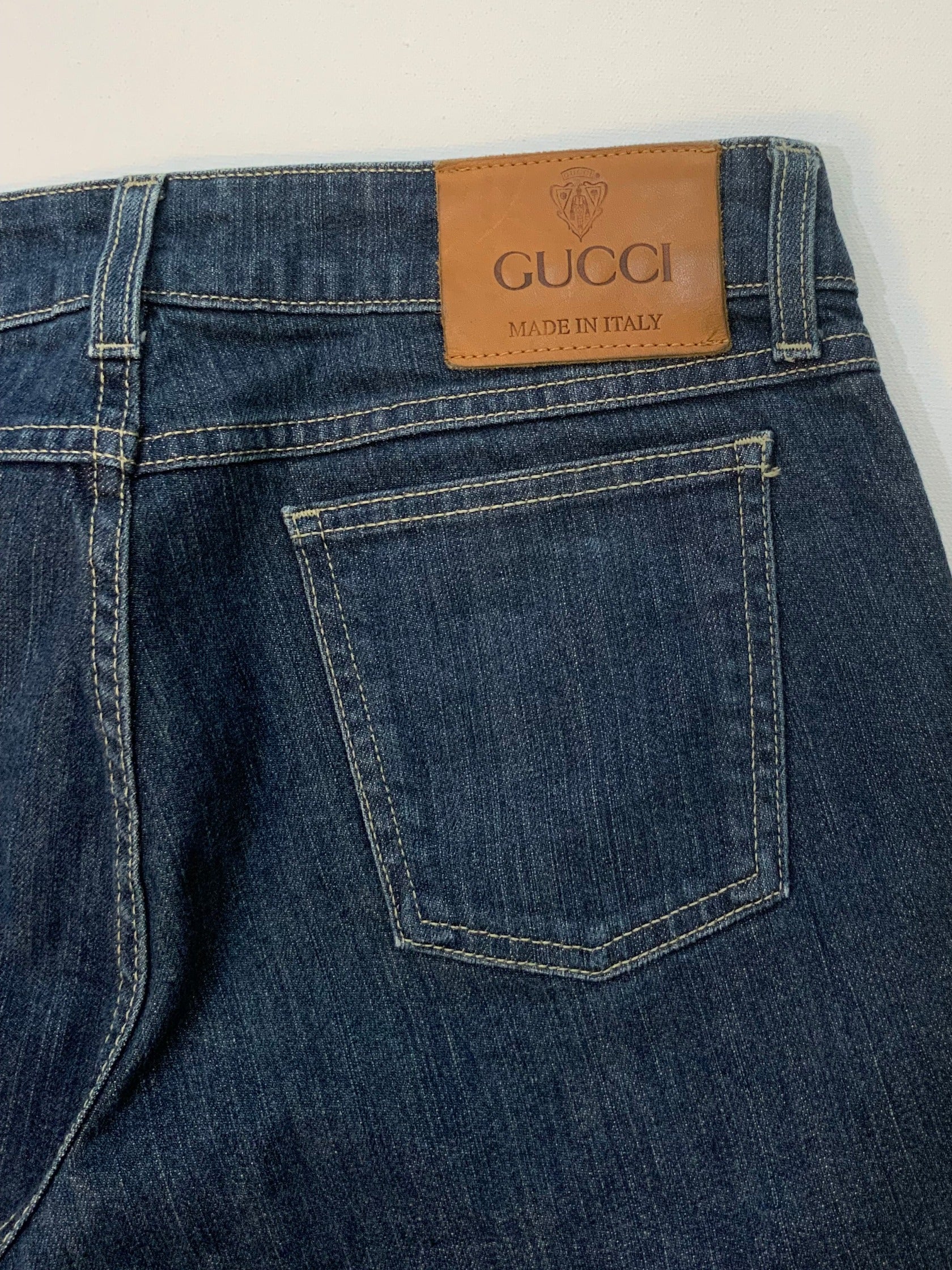 Gucci dark blue denim jeans in straight-leg cut with leather Gucci logo patch at back waistband, Italian size 44.