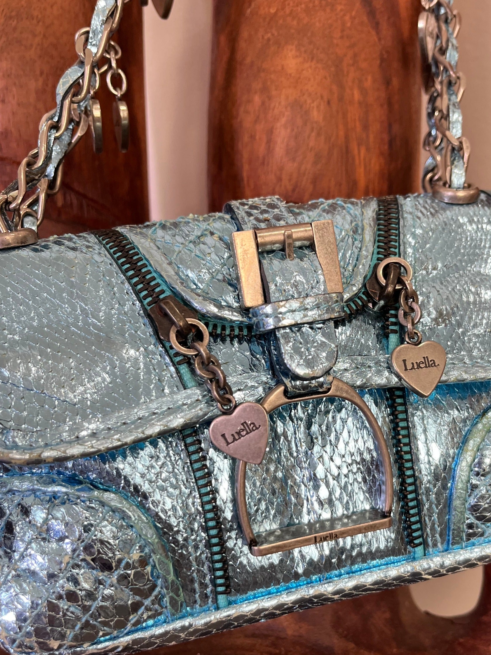 Vintage Luella metallic turquoise snakeskin handbag with silver buckle, chain strap, and signature heart charms, early 2000s Y2K It-bag.