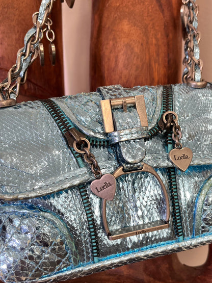 Vintage Luella metallic turquoise snakeskin handbag with silver buckle, chain strap, and signature heart charms, early 2000s Y2K It-bag.