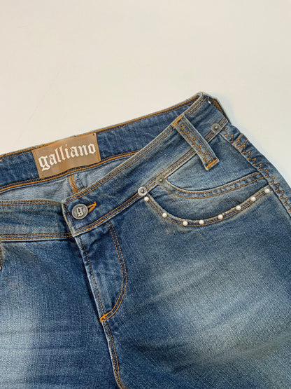 Vintage Galliano mid-wash denim jeans with pearl studded front pockets, embellished back pocket patch with pearls and silver detail, and cropped hem.