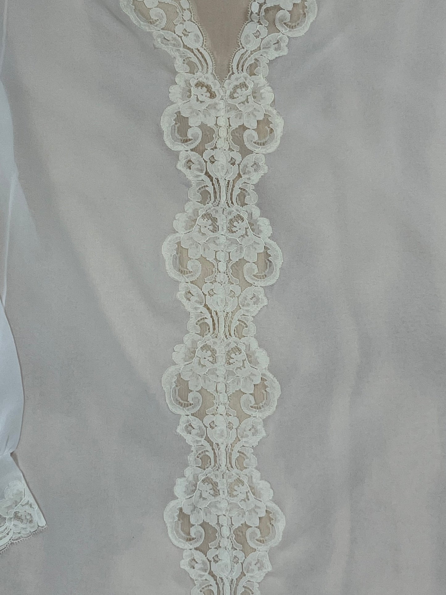 Detail of floral lace trim running down front of vintage Pucci tunic.