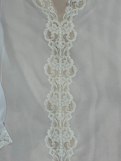 Detail of floral lace trim running down front of vintage Pucci tunic.
